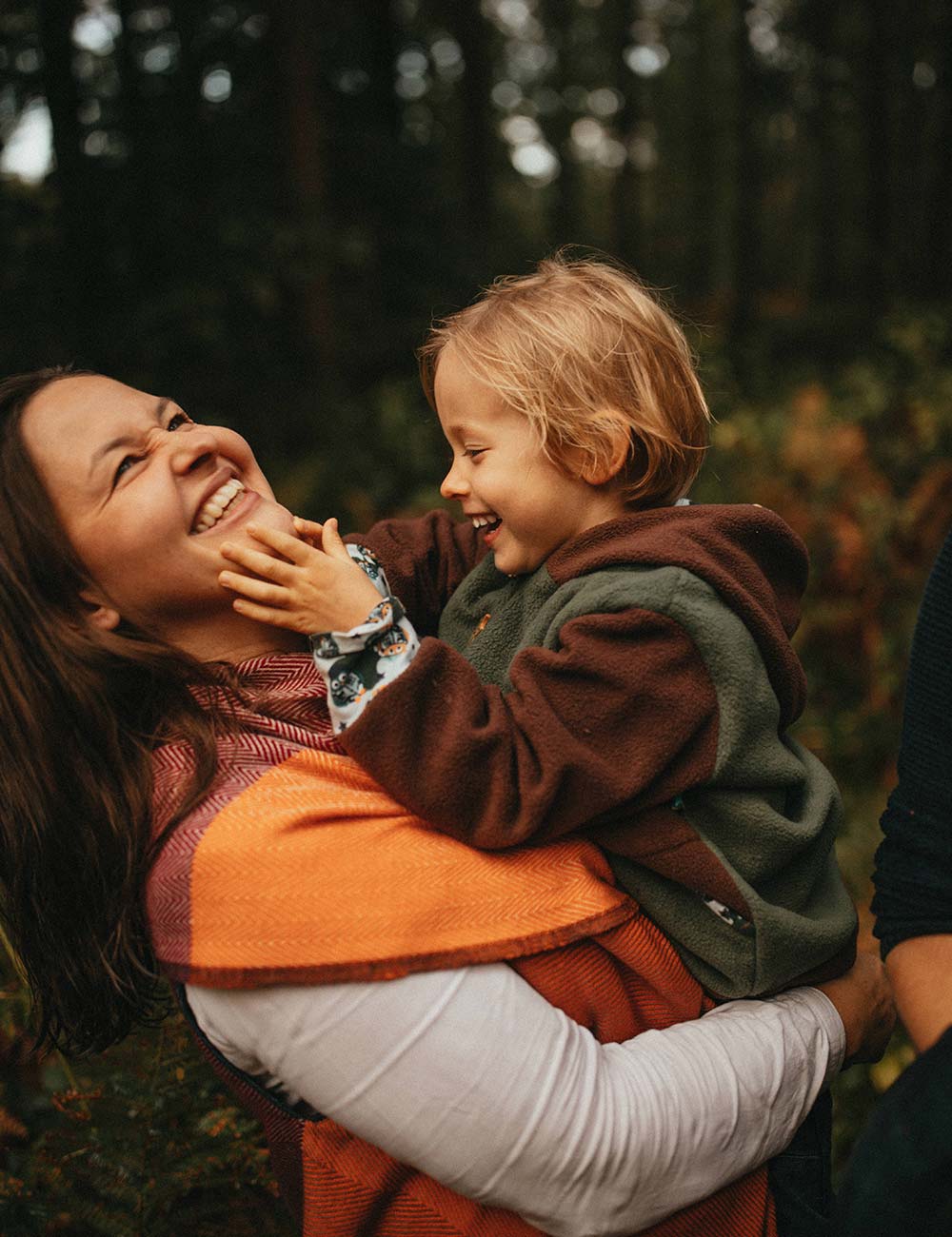 Mutter und Kind im Arm lachen zusammen.